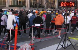 In white shirt with black tights starting the watch at 4:54.